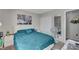 Bright bedroom featuring teal bedding and a large mirror at 6796 Pacific Craft Ln, Las Vegas, NV 89122