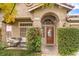 Inviting front entry with a wooden door and well-maintained landscaping at 1675 English Rose Dr, Las Vegas, NV 89142