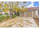 Two-car garage with driveway and landscaping at 1675 English Rose Dr, Las Vegas, NV 89142