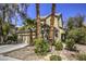 Two-story house with landscaped yard, two-car garage, and palm trees at 11215 Piazzale St, Las Vegas, NV 89141