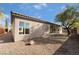 Backyard with gravel, tree and stucco wall at 2365 Black River Falls Dr, Henderson, NV 89044