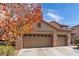 Two-story home with a two-car garage and brick facade at 3040 Lenoir St, Las Vegas, NV 89135