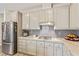 Modern kitchen with white cabinets, granite countertops, and stainless steel appliances at 3040 Lenoir St, Las Vegas, NV 89135