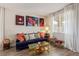 Cozy living room features a blue sofa, gold coffee table, and large artwork at 3040 Lenoir St, Las Vegas, NV 89135