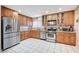 Spacious kitchen with stainless steel appliances and light wood cabinets at 571 Macbrey Dr, Las Vegas, NV 89123