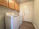 Laundry room with washer, dryer, and upper cabinets at 6824 Little Brook St, Las Vegas, NV 89131