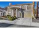 Two-story home with a tile roof, attached garage, and landscaped front yard at 2430 Antler Point Dr, Henderson, NV 89074