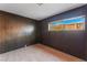 Bedroom with wood paneled walls and a window offering natural light at 6120 Edgewood Cir, Las Vegas, NV 89107