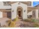 Welcoming front entry with brick walkway, arched entryway, and potted plants at 4050 Peaceful Dune St, Las Vegas, NV 89129