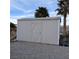 Large gray storage shed with an X-design door at 5830 Bonnie St, Pahrump, NV 89048