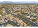 Aerial view of a residential neighborhood featuring houses, roads, and distant mountains at 2020 Aspen Oak St, Las Vegas, NV 89134