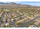 Aerial view of a residential area with houses, roads, and mountains in the background at 2020 Aspen Oak St, Las Vegas, NV 89134