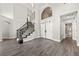 Elegant entryway with a curved staircase and hardwood floors at 2020 Aspen Oak St, Las Vegas, NV 89134