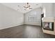 Living room with hardwood floors, fireplace, and a ceiling fan at 2020 Aspen Oak St, Las Vegas, NV 89134