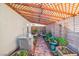 Lush garden area with various plants and a wooden pergola at 2828 Cattail Cove St, Laughlin, NV 89029