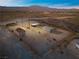 Aerial view of property with stables and a small shed, set in a desert landscape at 11875 Maggie Ave, Las Vegas, NV 89166