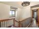 Elegant upstairs hallway with wood flooring, a chandelier, and a view at 11875 Maggie Ave, Las Vegas, NV 89166