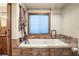 Spa-like bathroom with a large soaking tub and glass enclosure at 11875 Maggie Ave, Las Vegas, NV 89166