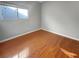 Simple bedroom with hardwood floors and a window at 771 Thorton Beach St, Henderson, NV 89015