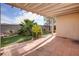 Covered patio with tile flooring and lush landscaping at 134 Skytop Dr, Henderson, NV 89015