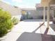 Desert backyard with painted cactus and sun design on the wall at 1920 Racine Dr, Las Vegas, NV 89156