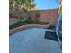 Landscaped backyard with concrete patio, artificial turf, and a brick retaining wall at 11261 Playa Caribe Ave, Las Vegas, NV 89138