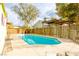 Inviting kidney-shaped pool with wooden fence and pergola at 310 Bonanza Way, Las Vegas, NV 89101