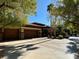 Two-car garage with wood doors and stone accents at 7110 Crowntop Cir, Las Vegas, NV 89118