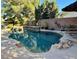 Relaxing pool area featuring a freeform pool, spa, and ample lounge space at 7110 Crowntop Cir, Las Vegas, NV 89118