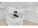 Modern kitchen with white cabinets, quartz countertops and gold faucet at 2110 Los Feliz St # 1037, Las Vegas, NV 89156