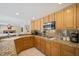 Kitchen with granite countertops, wood cabinets and gas cooktop at 9404 Low Tide Ct, Las Vegas, NV 89117