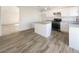 Eat-in kitchen boasting white cabinets and wood-look flooring at 2617 Early Vista St, Las Vegas, NV 89142