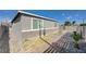 Brick paved side yard with landscaping and modern gray house exterior at 310 Jackson Ave, Las Vegas, NV 89106