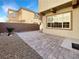 Private backyard patio with paver stones and gravel landscaping at 9390 Cowboy Rain Dr, Las Vegas, NV 89178