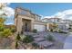 Two-story home with a white garage door and landscaped front yard at 12429 Alpenglow Ct, Las Vegas, NV 89138