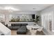 Modern living room with grey sectional sofa and white dining set at 10881 Pentland Downs St, Las Vegas, NV 89141