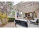 Relaxing backyard patio with pergola, seating area, and fountain at 3187 Castle Canyon Ave, Henderson, NV 89052