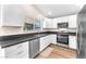 Modern kitchen with white cabinets, stainless steel appliances, and dark countertops at 4645 Concord Village Dr, Las Vegas, NV 89108