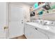 Bright laundry room, washer, dryer, and ample shelving at 4645 Concord Village Dr, Las Vegas, NV 89108