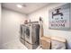 Laundry room with washer, dryer, and built-in shelving at 10940 Oregano Ave, Las Vegas, NV 89166