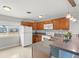 Updated kitchen, featuring wood cabinets, and gray countertops at 2009 Hassell Ave, North Las Vegas, NV 89032