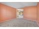 Empty carpeted bedroom with coral walls at 3524 Round Valley Way, Las Vegas, NV 89129