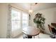 Cozy breakfast nook with wood table and chairs, and a wall of windows at 3949 Weybridge Dr, Las Vegas, NV 89121