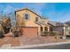 Two-story house with tan exterior, brown garage door, and landscaped front yard at 4212 Seclusion Bay Ave, North Las Vegas, NV 89081