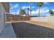 Large backyard with gravel and a wooden fence offering privacy at 4306 Swandale Ave, Las Vegas, NV 89121