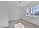 Simple bedroom with large window and carpeted floors at 4306 Swandale Ave, Las Vegas, NV 89121