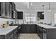 Modern kitchen with dark cabinets, quartz counters and breakfast bar at 4306 Swandale Ave, Las Vegas, NV 89121