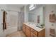 Bathroom with a shower/tub combo, single vanity, and wood-style flooring at 50 Aura De Blanco St # 17101, Henderson, NV 89074