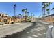 Gated community entrance with palm trees, landscaping, and a central fountain at 50 Aura De Blanco St # 17101, Henderson, NV 89074