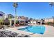 Community pool with covered pergola, lounge chairs, and townhomes in the background at 50 Aura De Blanco St # 17101, Henderson, NV 89074